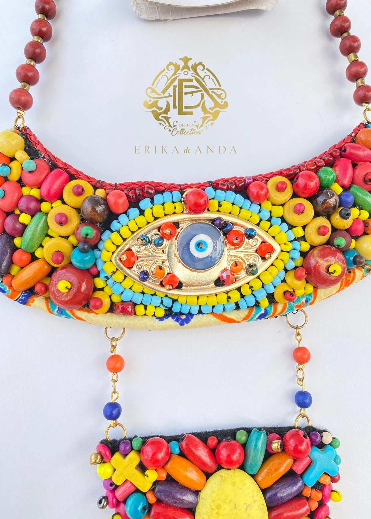 COLLAR DOS CAPAZ CON DISEÑO DE OJO CON ARETES